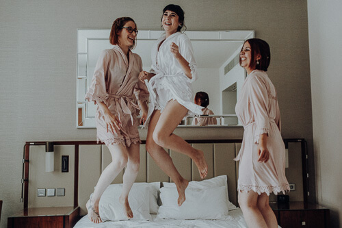 jumping and happy bride with her bridesmaids. we love relaxed weddings so much